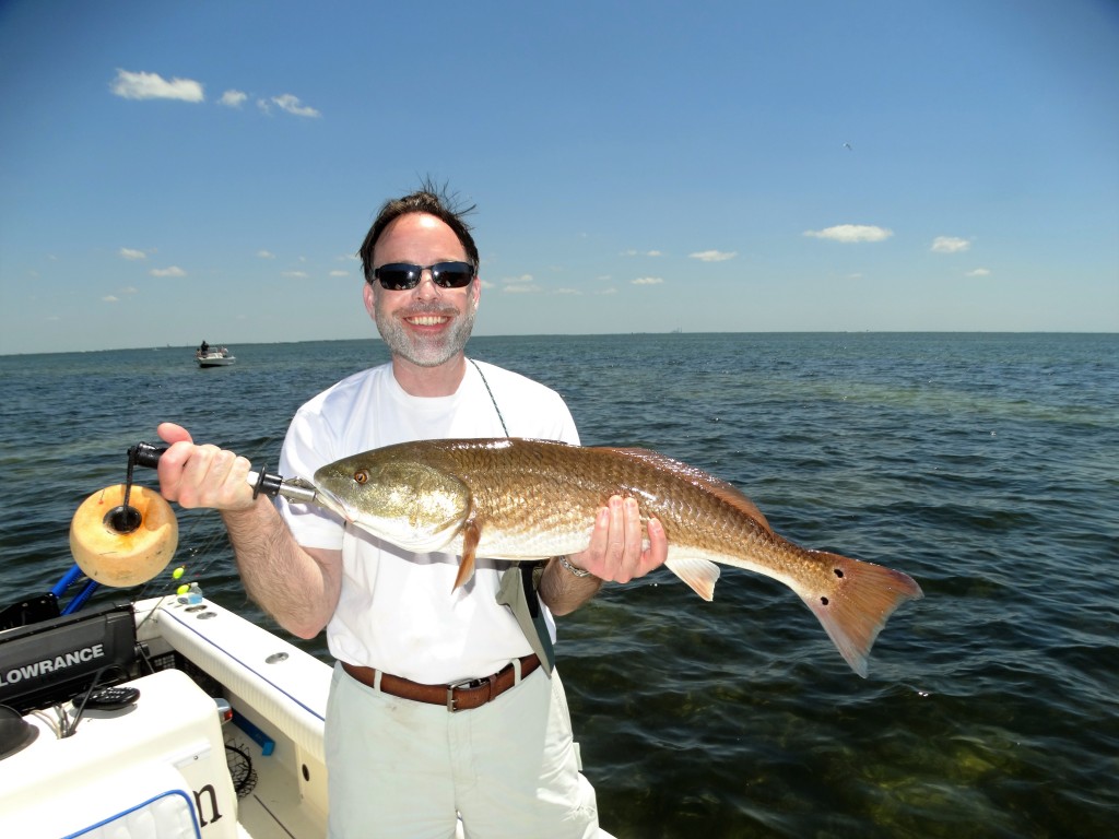 Dr. With a big redfish for the clear water area