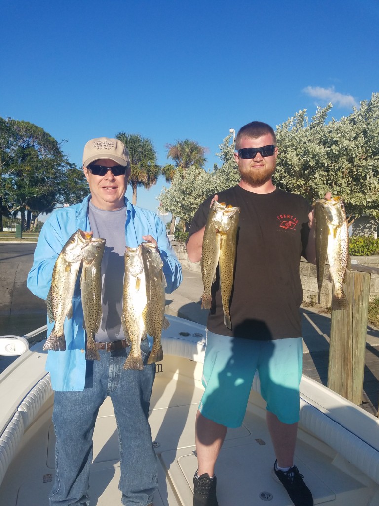 Rob and Robbie with a limit of trout caught on a guided fishing charter tour in safety harbor fl with capt.jared