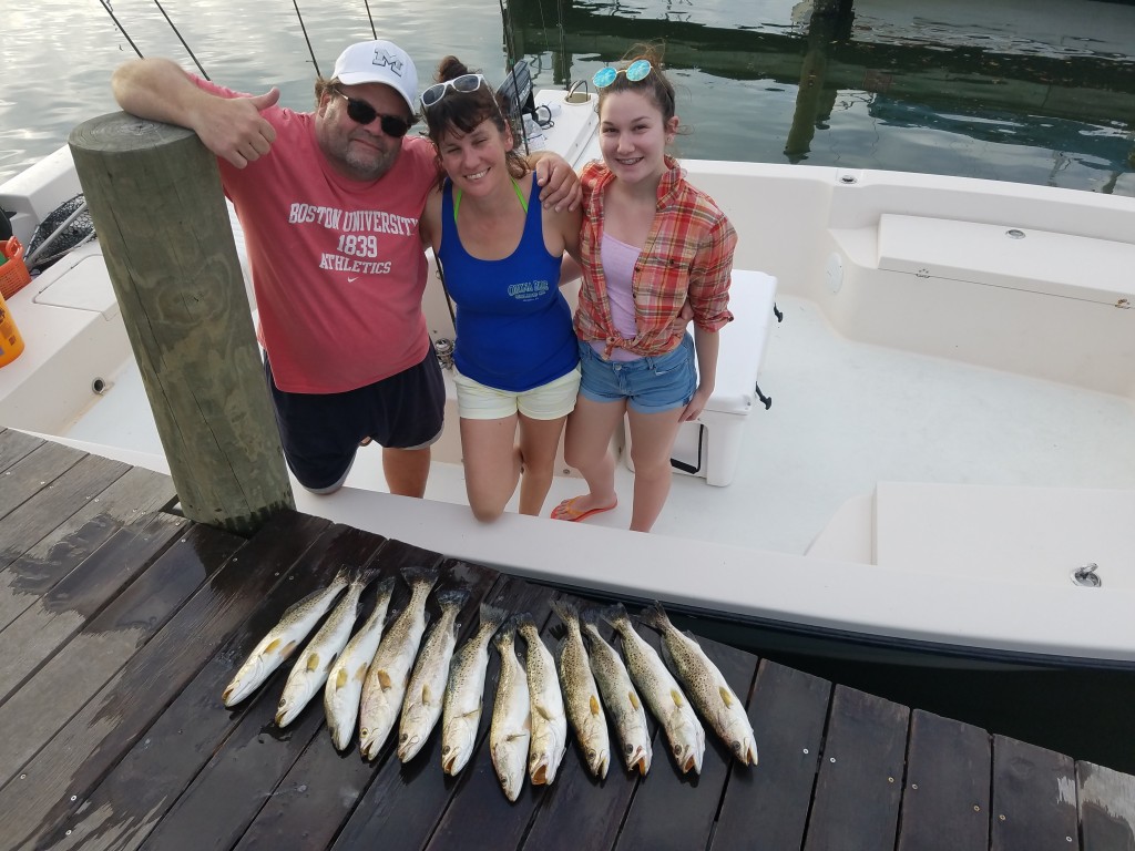 John, Cindy, Ash Trout limit on a clearwater beach fishing trip
