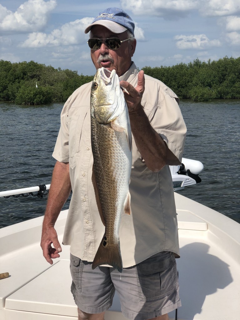 Dougs big Redfish caught while on a clearwater fishing charter trip